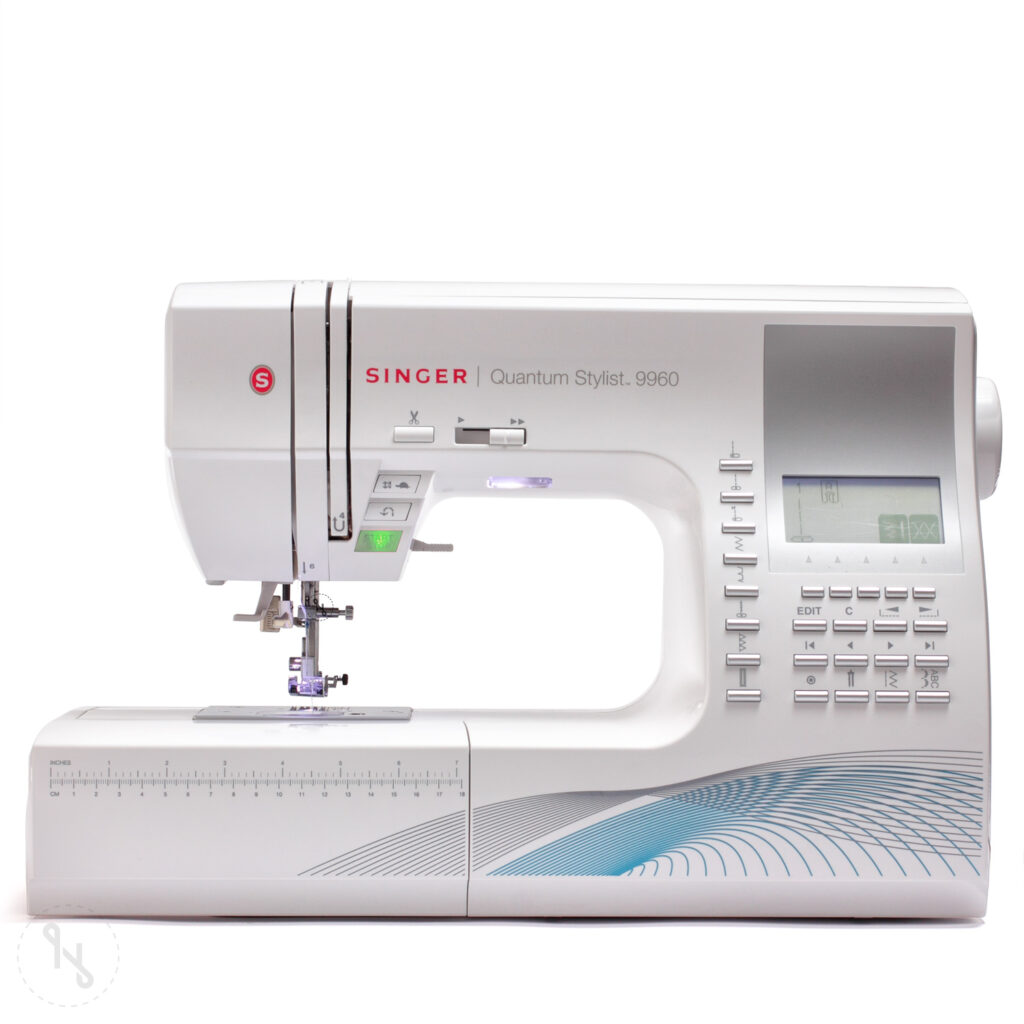 Singer Quantum Stylist 9960 sewing machine with a LCD screen and a large work area with a ruler on a white background for monogramming.