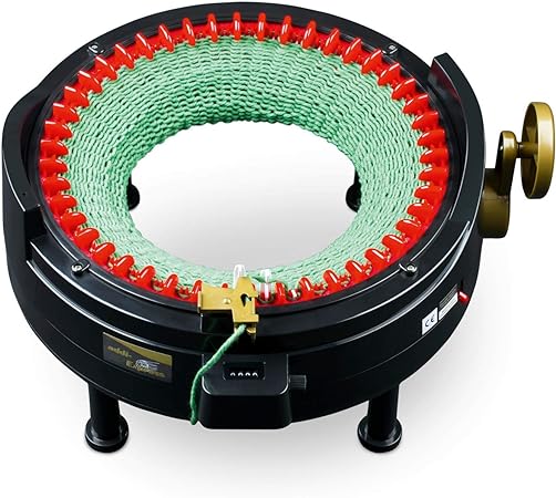A close-up of a circular knitting machine with red pegs and green yarn, suitable for beginners

