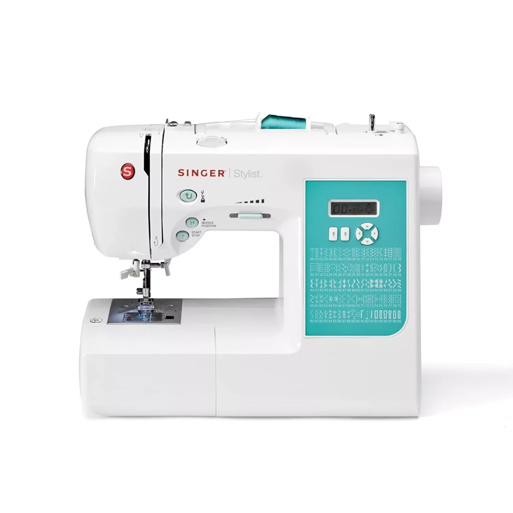 A close-up photo of a Singer 7258 Stylist computerized sewing machine with a white body and aqua accents, featuring 100 built-in stitch patterns displayed on the front panel, perfect for creating intricate Valentine’s Day sewing projects.”